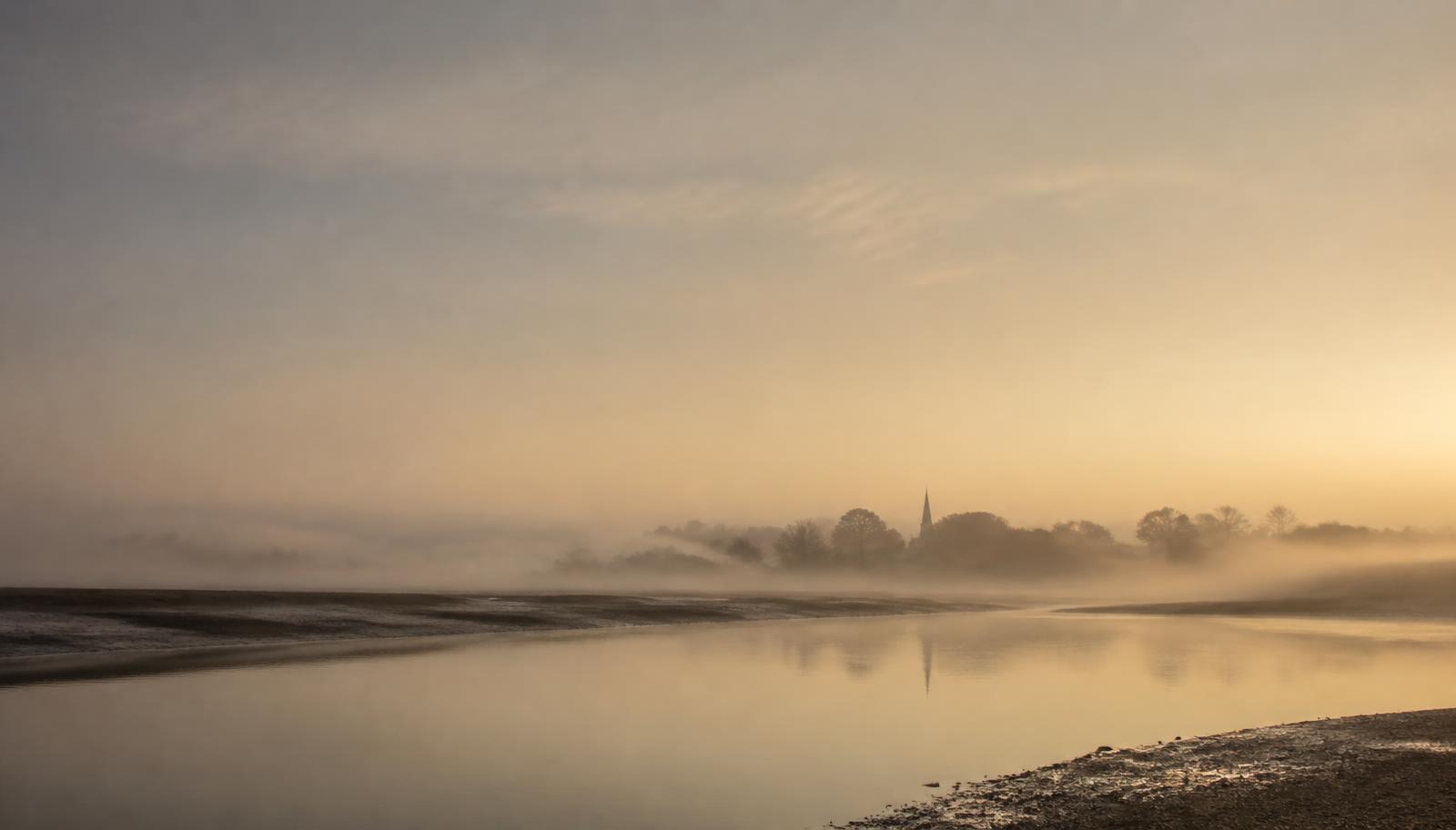 Quiet Kent river landscape at dawn with soft mist and muted light