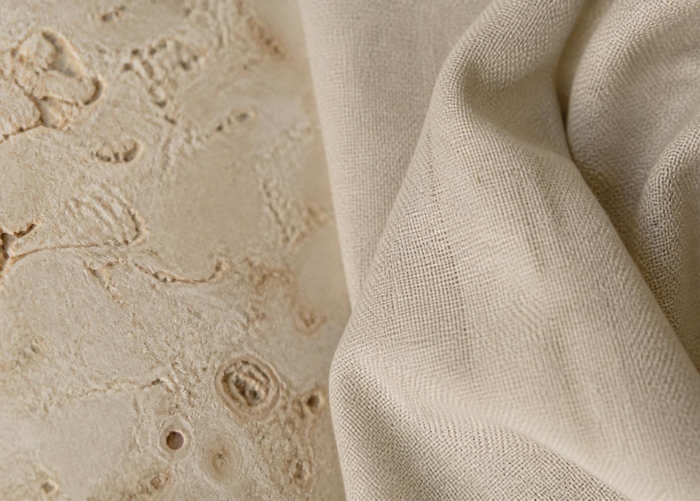 Detail of limestone and linen textures in soft neutral daylight